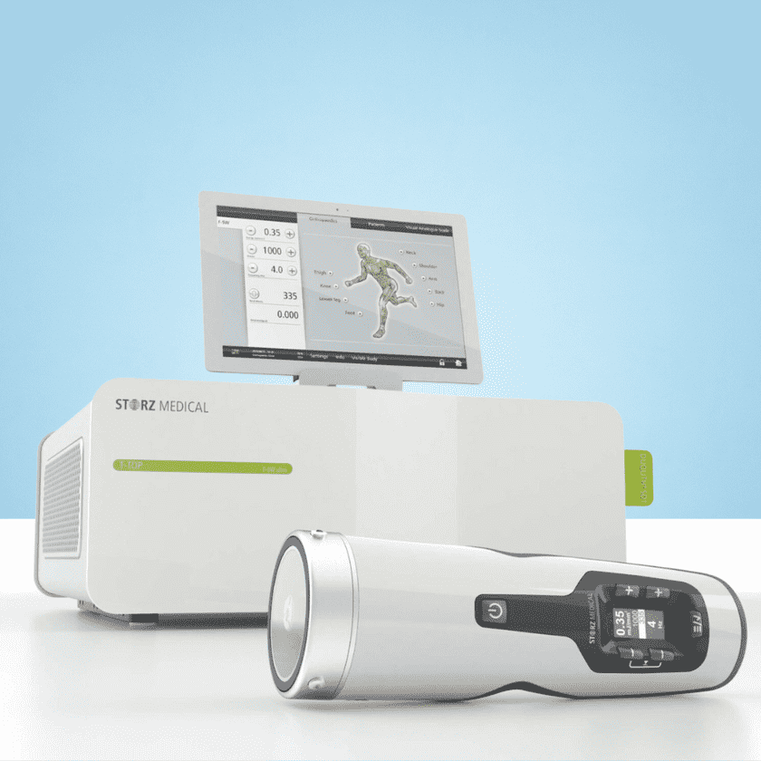 Medical equipment from Storz Medical, featuring a sleek console and handheld device displaying patient diagnostics on a monitor.